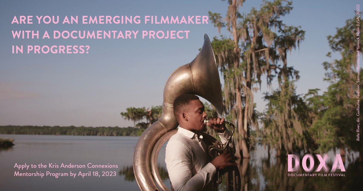 Pink text and logo on a film still that shows the side-profile of a man playing a large trumpet. Water and trees in the background, late afternoon skies. Still from Belle River, 2021