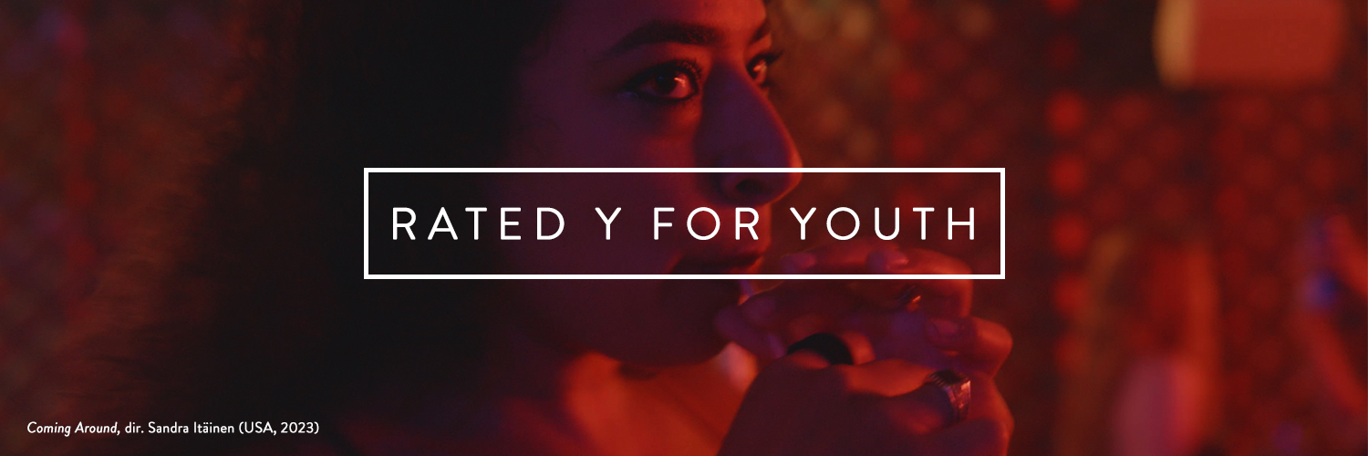 Film still showing a woman sipping a drink in red light, dimly lit. White text within a white box reads Rated Y For Youth. Film still from Coming Around, 2023