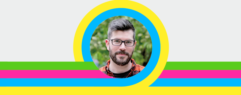 A man with glasses and a beard, wearing a red checkered shirt, is centered in a circular frame. The frame has yellow, blue, green, pink, and yellow stripes extending horizontally against a light gray background. The overall tone is vibrant and cheerful.